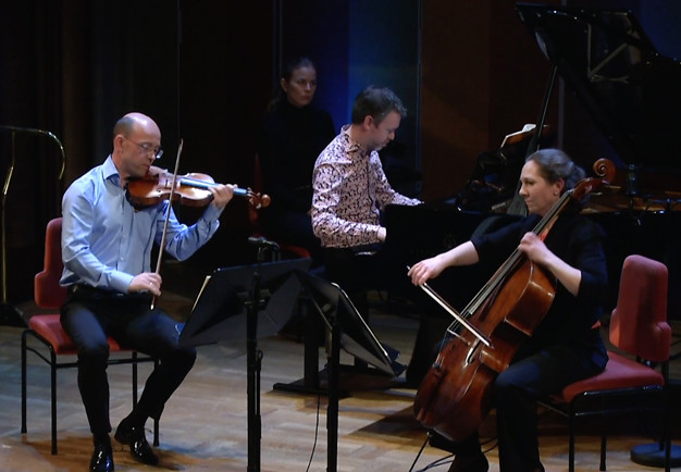 Three musicians playing. Photo.